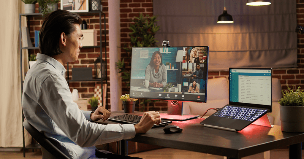 Man working from home video chats with coworkers